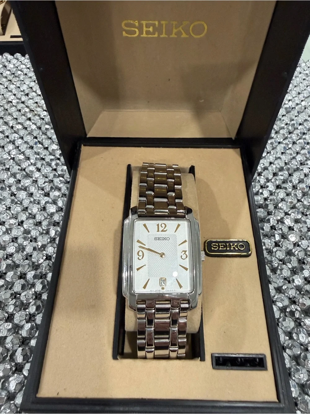 Seiko Silver Watch with Gold Accents and Rectangular Dial